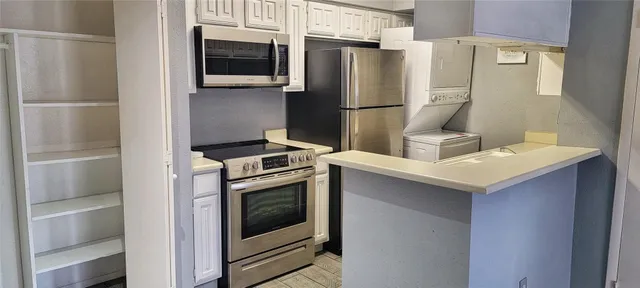 a kitchen with a refrigerator sink and stove