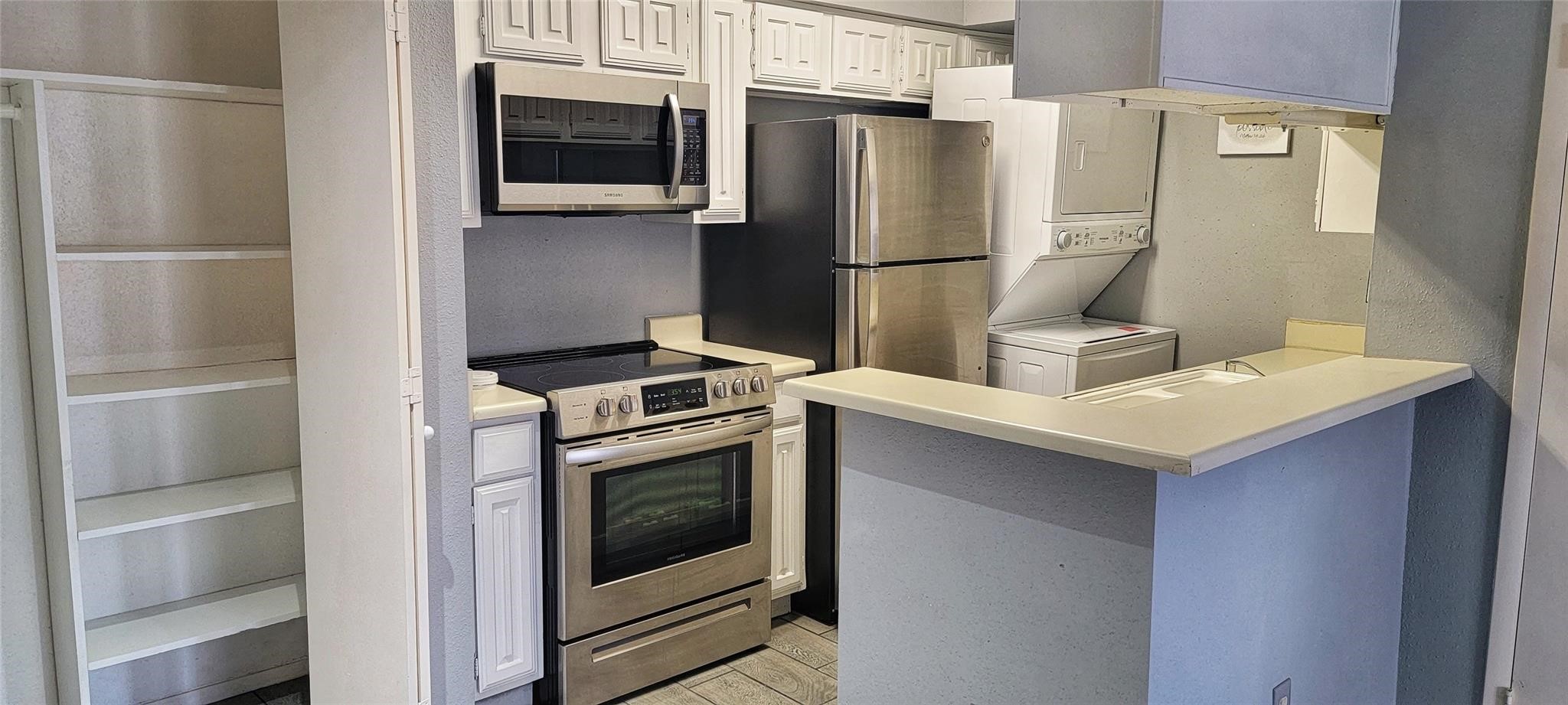 2110 Wilcrest Drive, Unit 113 Houston, TX 77077 - Photo 3 of 22 a kitchen with a refrigerator sink and stove