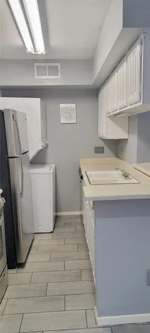 a utility room with a sink a washer and dryer
