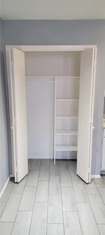 a view of walk in closet with empty racks