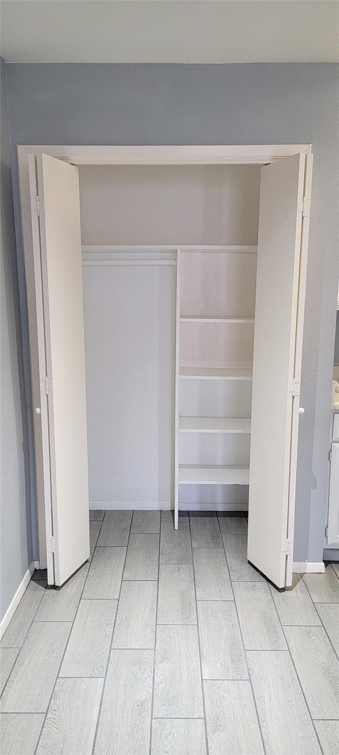 2110 Wilcrest Drive, Unit 113 Houston, TX 77077 - Photo 5 of 22 a view of walk in closet with empty racks