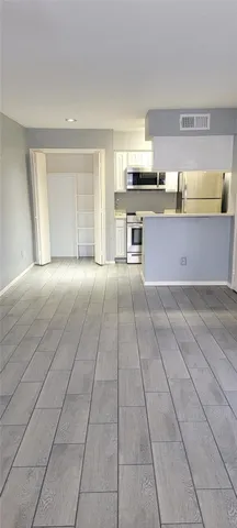 a large kitchen with stainless steel appliances granite countertop a large stove top oven and cabinets