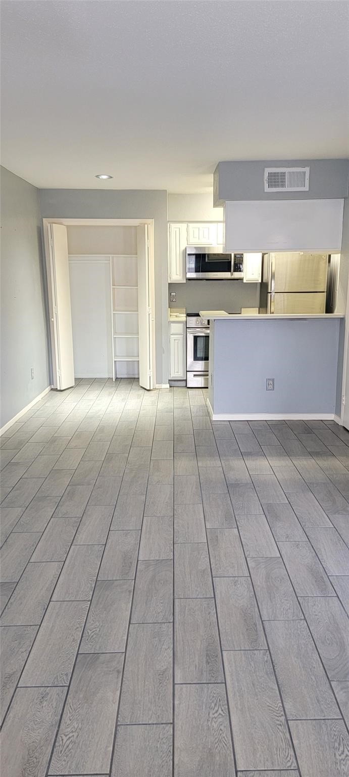 2110 Wilcrest Drive, Unit 113 Houston, TX 77077 - Photo 6 of 22 a large kitchen with stainless steel appliances granite countertop a large stove top oven and cabinets