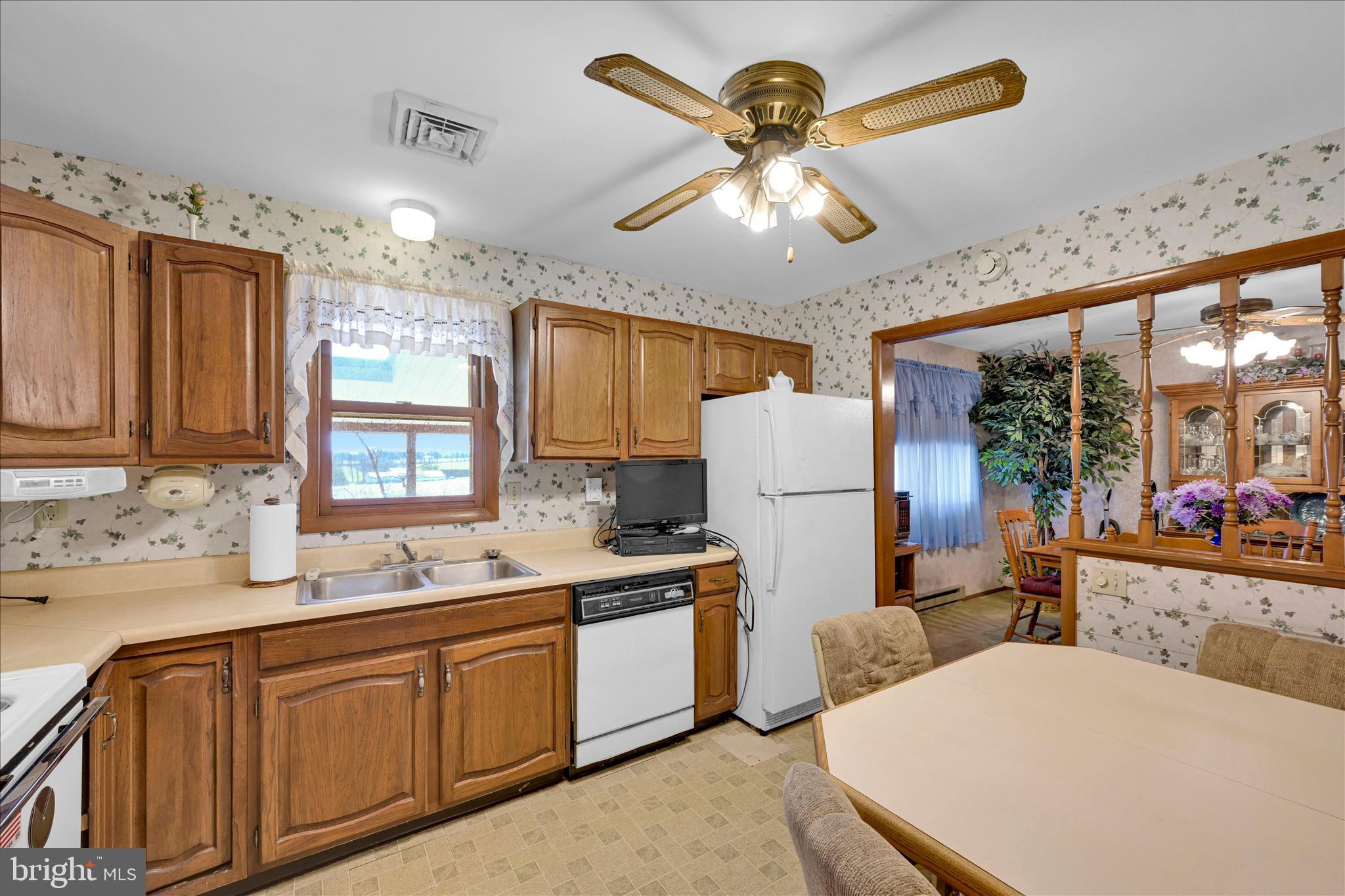 649 Stone Hill Road Shoemakersville, PA 19555 - Photo 19 of 43 a kitchen with stainless steel appliances a table chairs and a refrigerator
