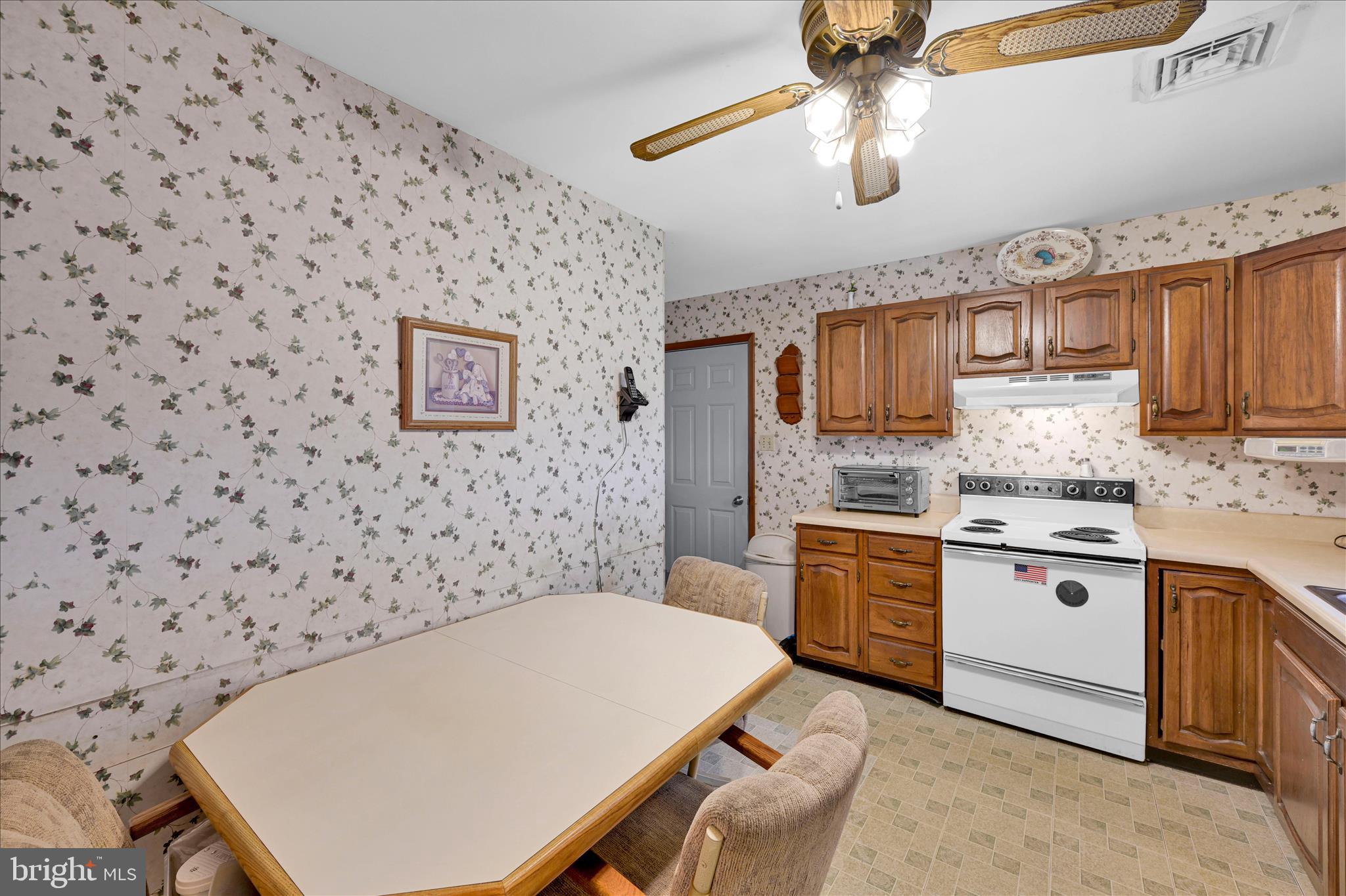 649 Stone Hill Road Shoemakersville, PA 19555 - Photo 21 of 43 a kitchen with a white cabinets sink and stove