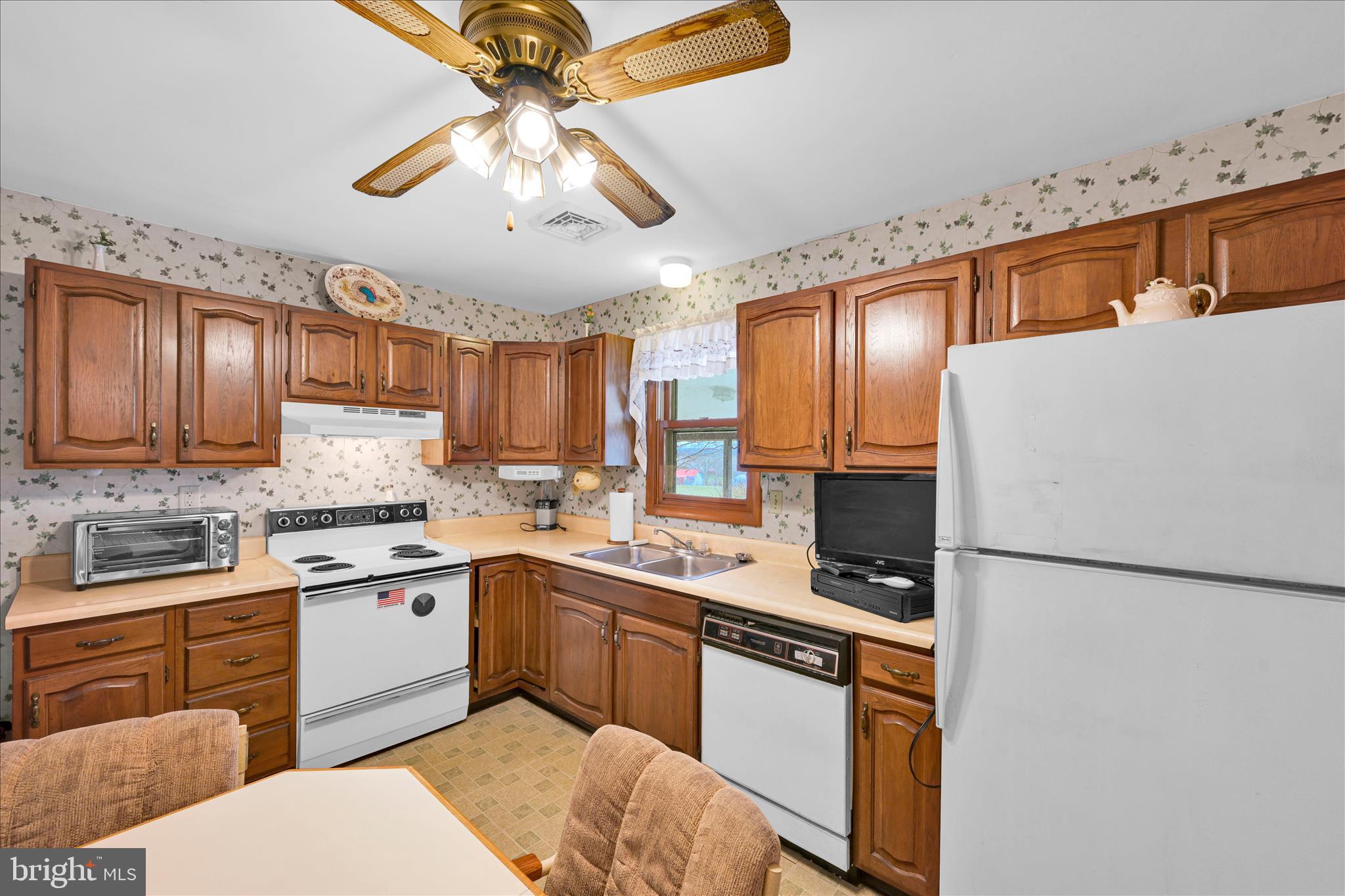 649 Stone Hill Road Shoemakersville, PA 19555 - Photo 22 of 43 a kitchen with stainless steel appliances granite countertop a sink stove and refrigerator
