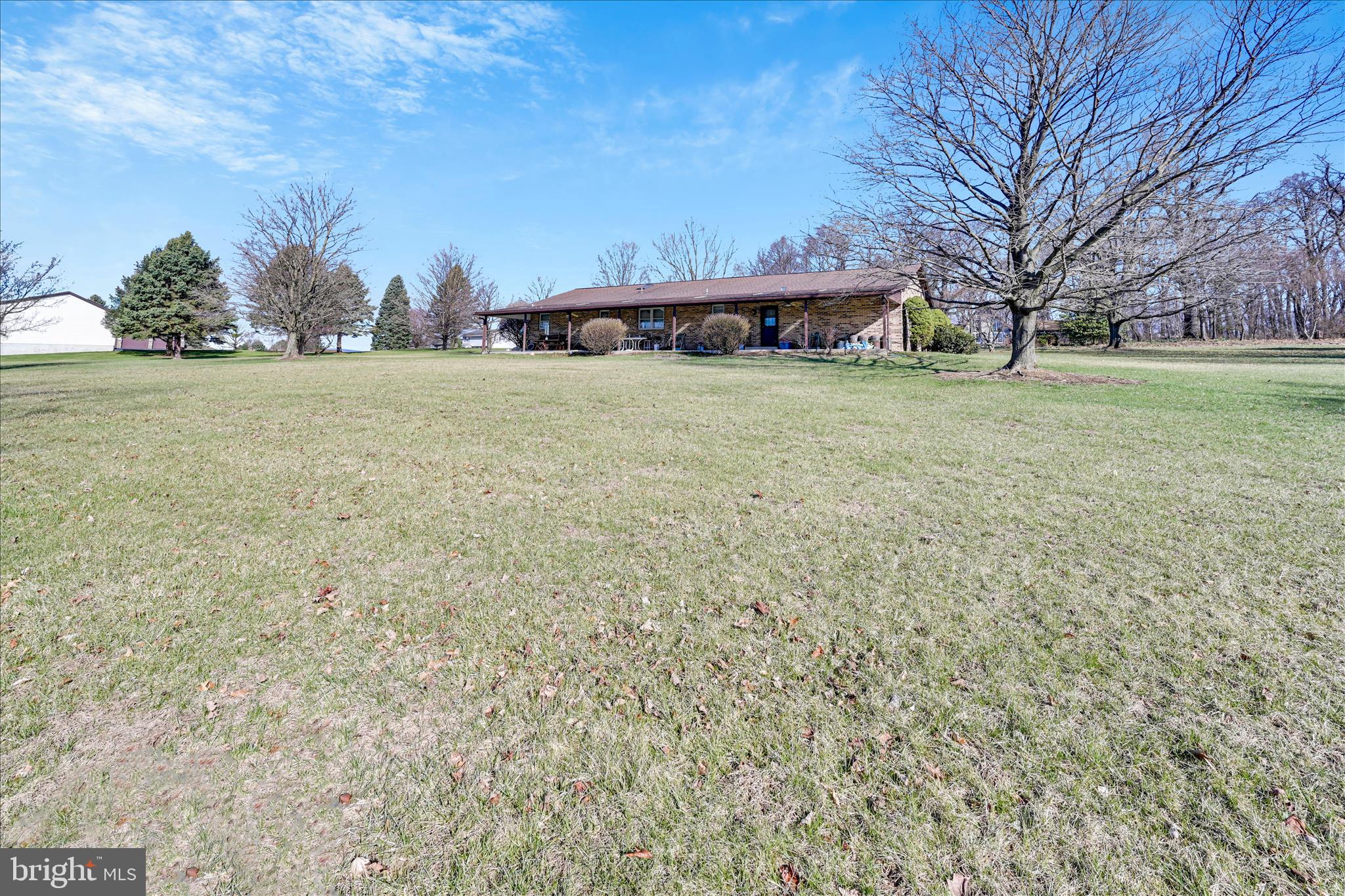 649 Stone Hill Road Shoemakersville, PA 19555 - Photo 34 of 43 a view of a yard with an house and trees in the background