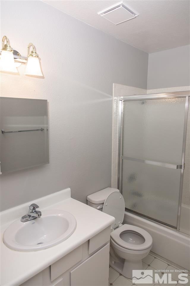 6545 Lotus Street Reno, NV 89506 - Photo 13 of 28 a bathroom with a sink toilet and shower