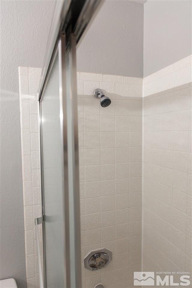 6545 Lotus Street Reno, NV 89506 - Photo 14 of 28 a bathroom with a glass shower door