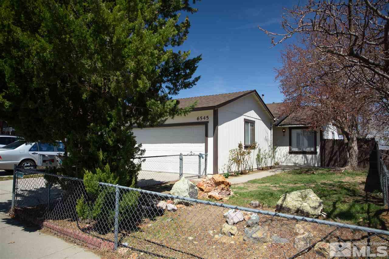 6545 Lotus Street Reno, NV 89506 - Photo 2 of 28 a front view of a house with a yard