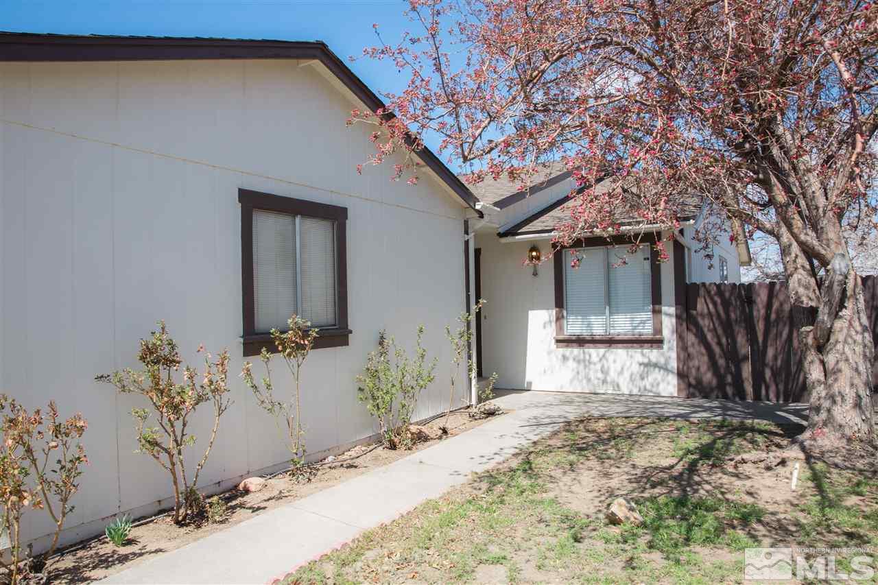 6545 Lotus Street Reno, NV 89506 - Photo 28 of 28 a front view of a house with a yard and garage