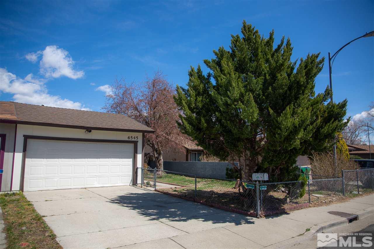 6545 Lotus Street Reno, NV 89506 - Photo 3 of 28 a front view of a house with a yard
