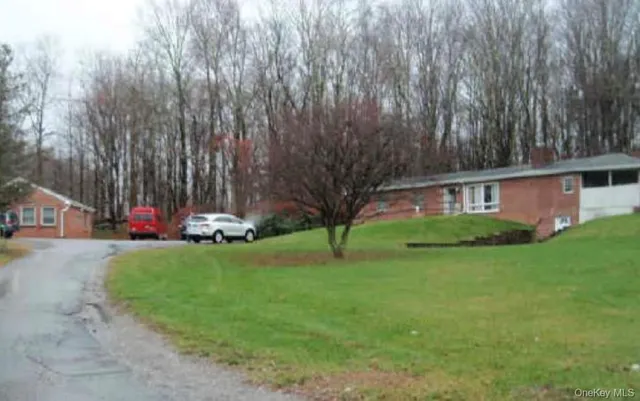 a view of a house with a yard and tree s