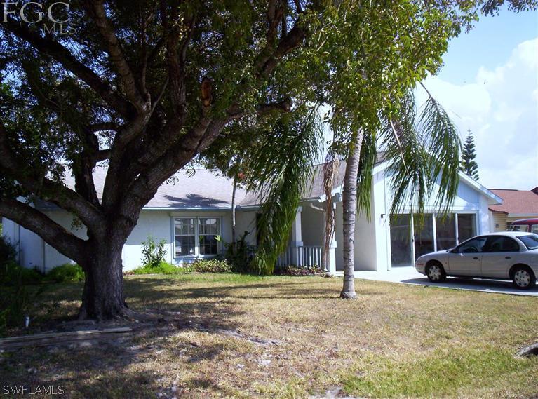 a house with palm tree in front of it