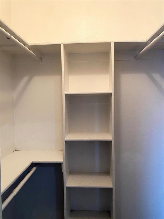 906 Parkplace Ridge Princeton, TX 75407 - Photo 22 of 31 Built-in closet shelving system featuring multiple storage rods and adjustable shelves