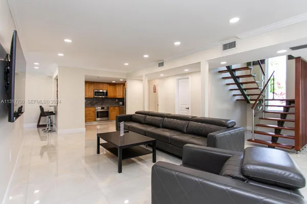 a living room with furniture and a flat screen tv