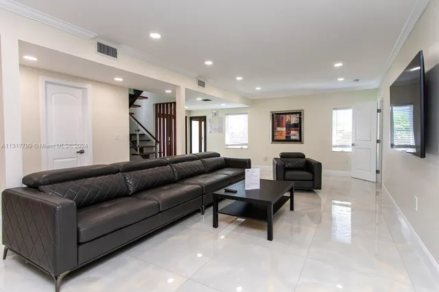 a living room with furniture and a piano