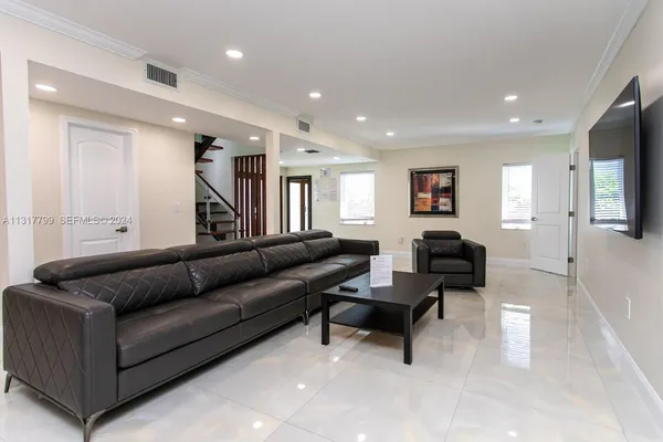 a living room with furniture and a piano