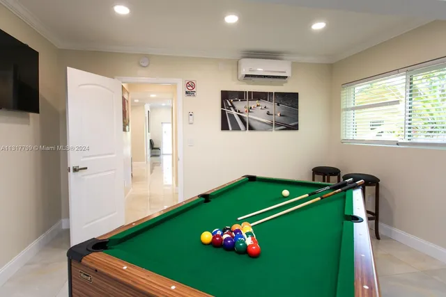 a room with pool table and screen