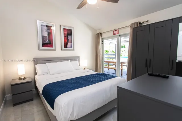 a bedroom with a large bed and a window