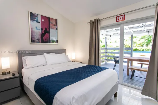 a bedroom with a large bed and a large window