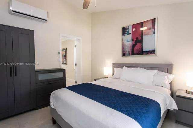 a bedroom with a bed and a painting on the wall