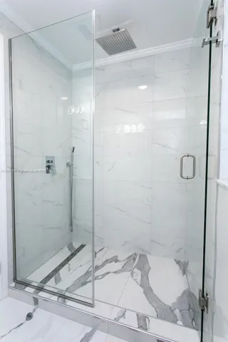 a bathroom with a granite countertop sink and shower