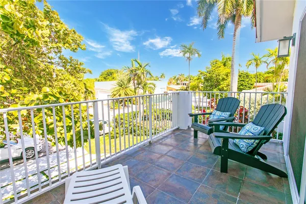 a view of a chairs and table in patio with swimming pool