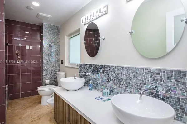 a bathroom with a toilet sink and mirror