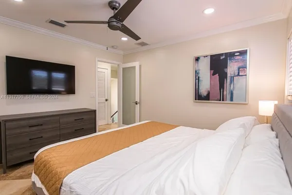 a bedroom with a bed and a flat screen tv