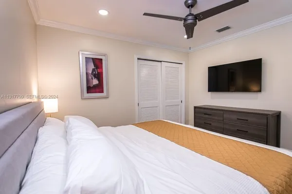 a bedroom with a bed and a flat screen tv