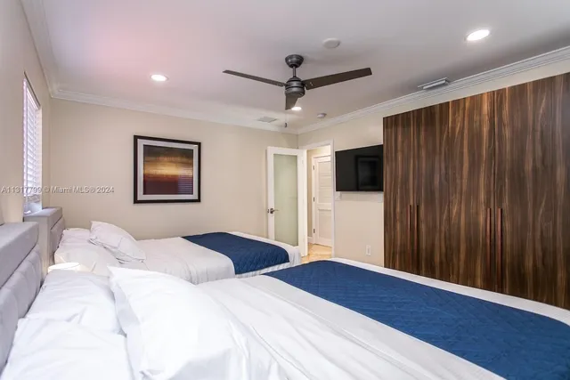 a bedroom with a bed and a flat screen tv
