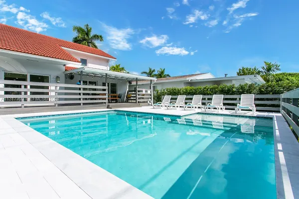 swimming pool view with a outdoor seating space