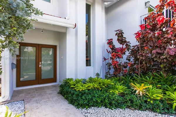 front view of a house with a potted plant
