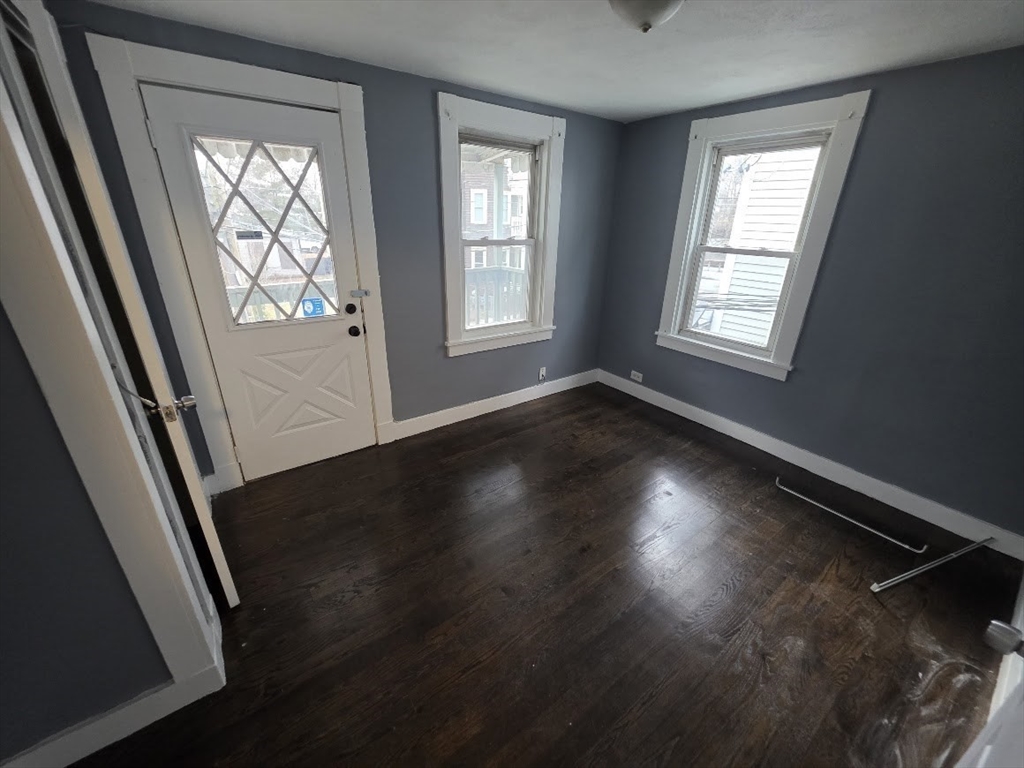 8 Dana, Unit 2 Boston, MA 02136 - Photo 2 of 9 a view of an empty room with wooden floor and a window
