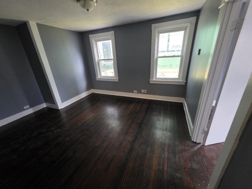8 Dana, Unit 2 Boston, MA 02136 - Photo 3 of 9 a view of an empty room with wooden floor and a window