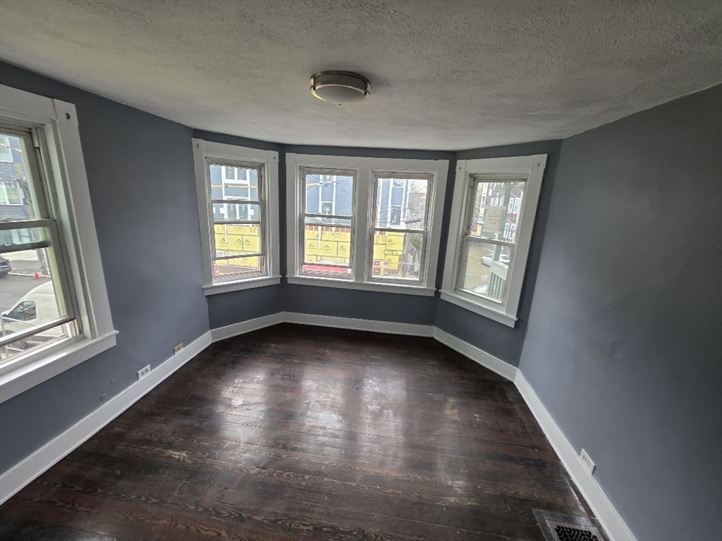 8 Dana, Unit 2 Boston, MA 02136 - Photo 4 of 9 a view of an empty room with wooden floor and a window