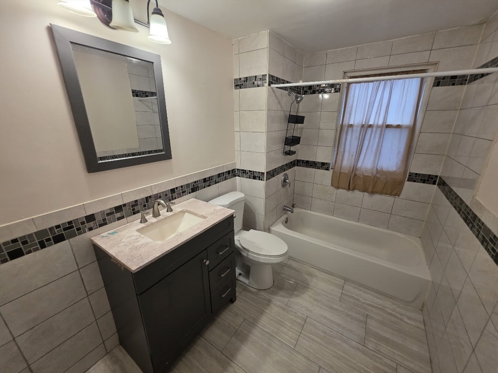 8 Dana, Unit 2 Boston, MA 02136 - Photo 6 of 9 a bathroom with a sink toilet and shower