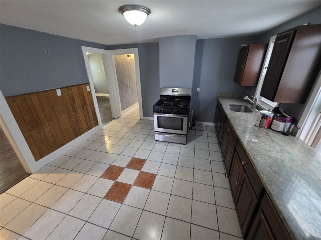 8 Dana, Unit 2 Boston, MA 02136 - Photo 9 of 9 a kitchen with stainless steel appliances a sink stove and cabinets