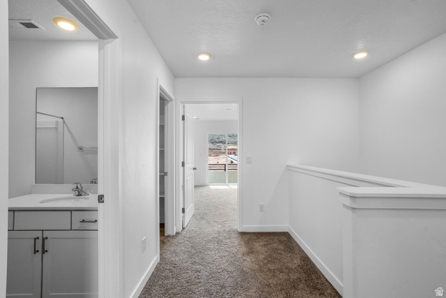 2194 Wolverine Way, Unit 2531 Washington, UT 84780 - Photo 32 of 52 Upper-level hallway with neutral carpeting, recessed lighting, and white walls