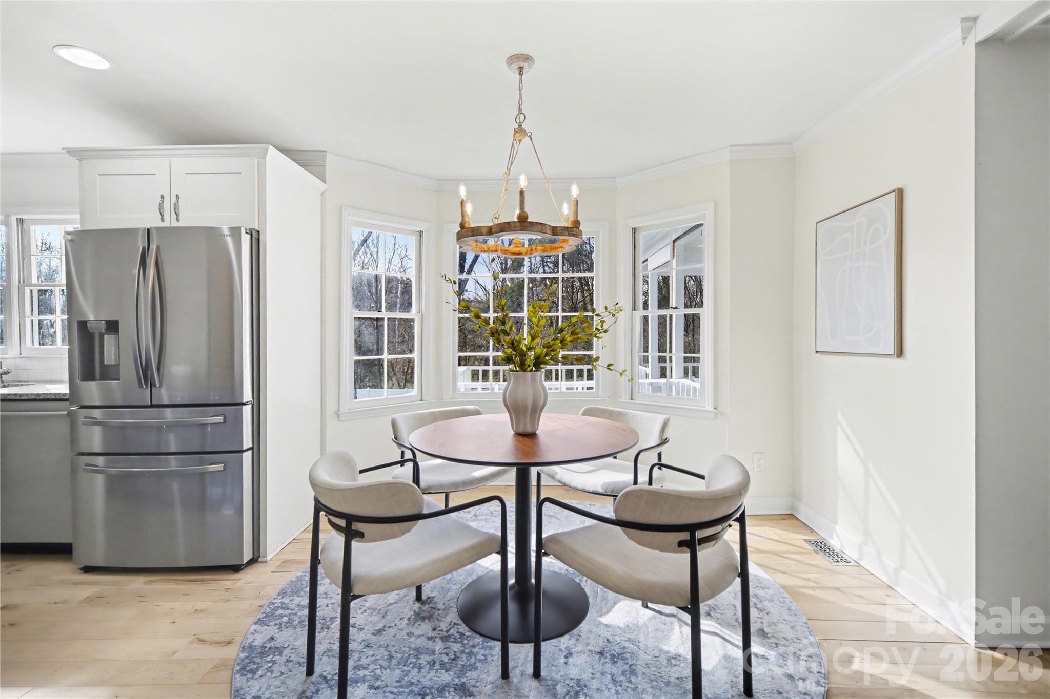 8330 Tifton Road Charlotte, NC 28226 - Photo 12 of 36 a kitchen with stainless steel appliances a dining table chairs and chandelier