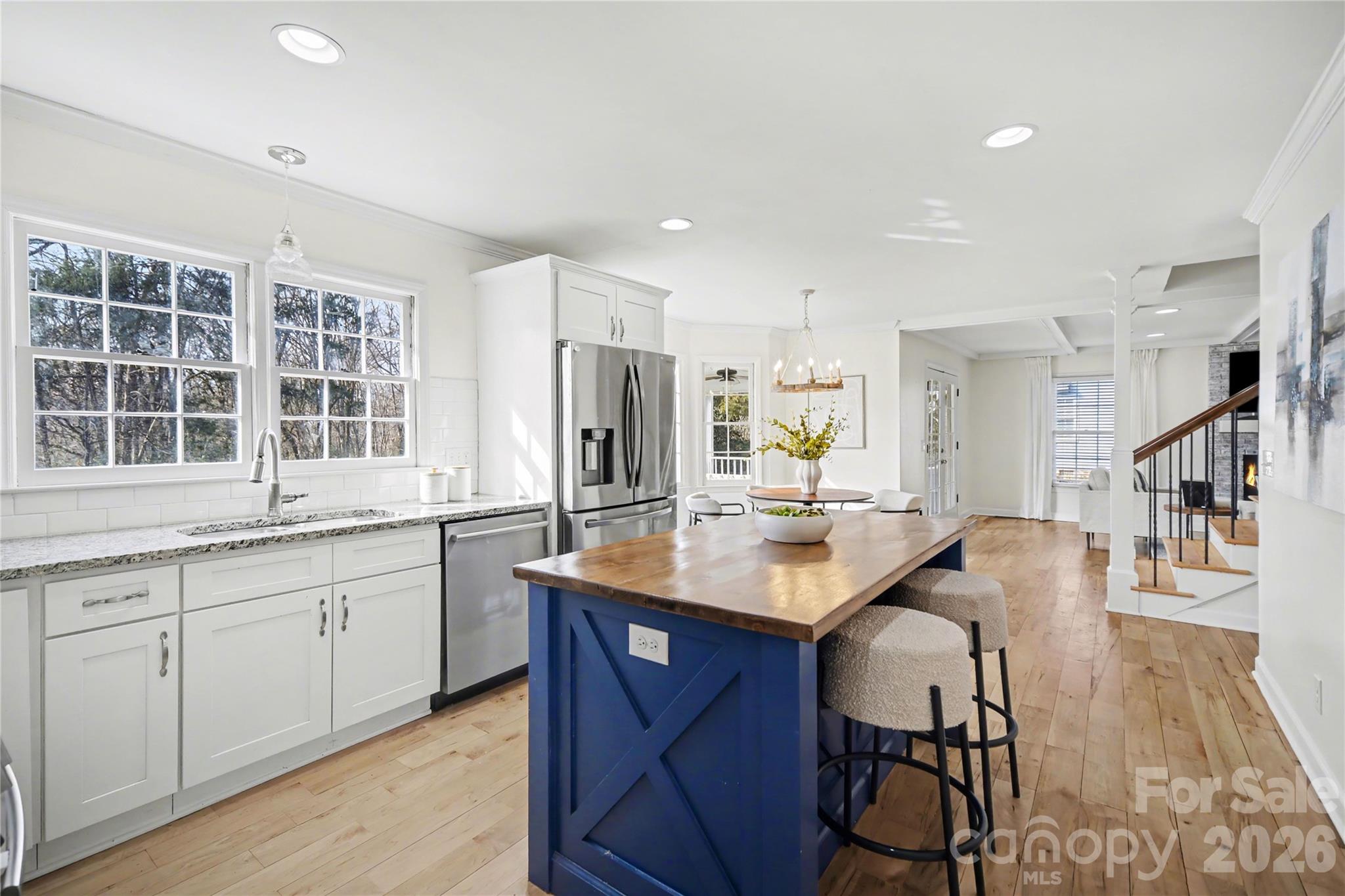8330 Tifton Road Charlotte, NC 28226 - Photo 15 of 36 a kitchen with center island and windows
