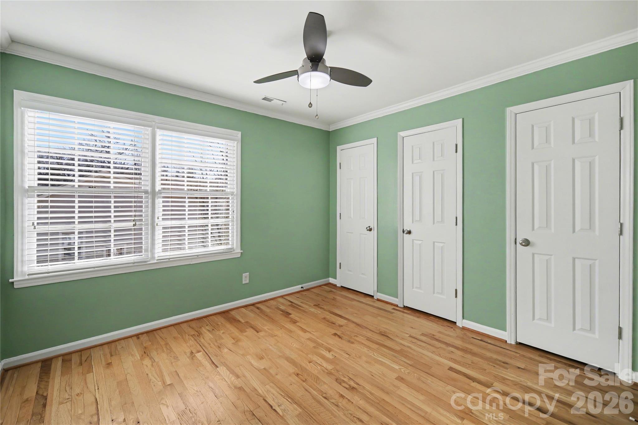 8330 Tifton Road Charlotte, NC 28226 - Photo 28 of 36 a view of empty room with wooden floor and fan