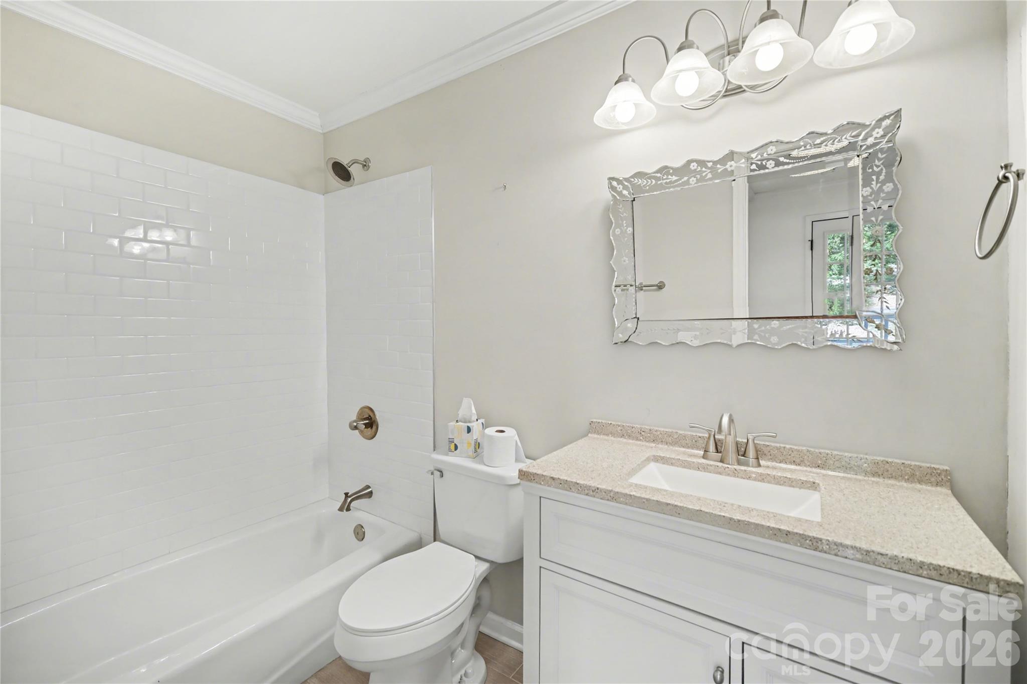 8330 Tifton Road Charlotte, NC 28226 - Photo 32 of 36 a bathroom with a sink a toilet and a mirror
