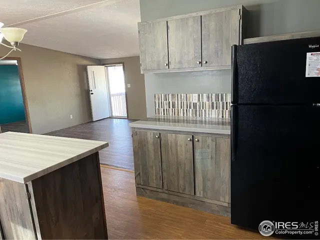 a kitchen with stainless steel appliances a refrigerator and cabinets