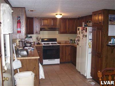 6023 Short Road Nazareth, PA 18064 - Photo 8 of 10 a kitchen with a stove and a refrigerator