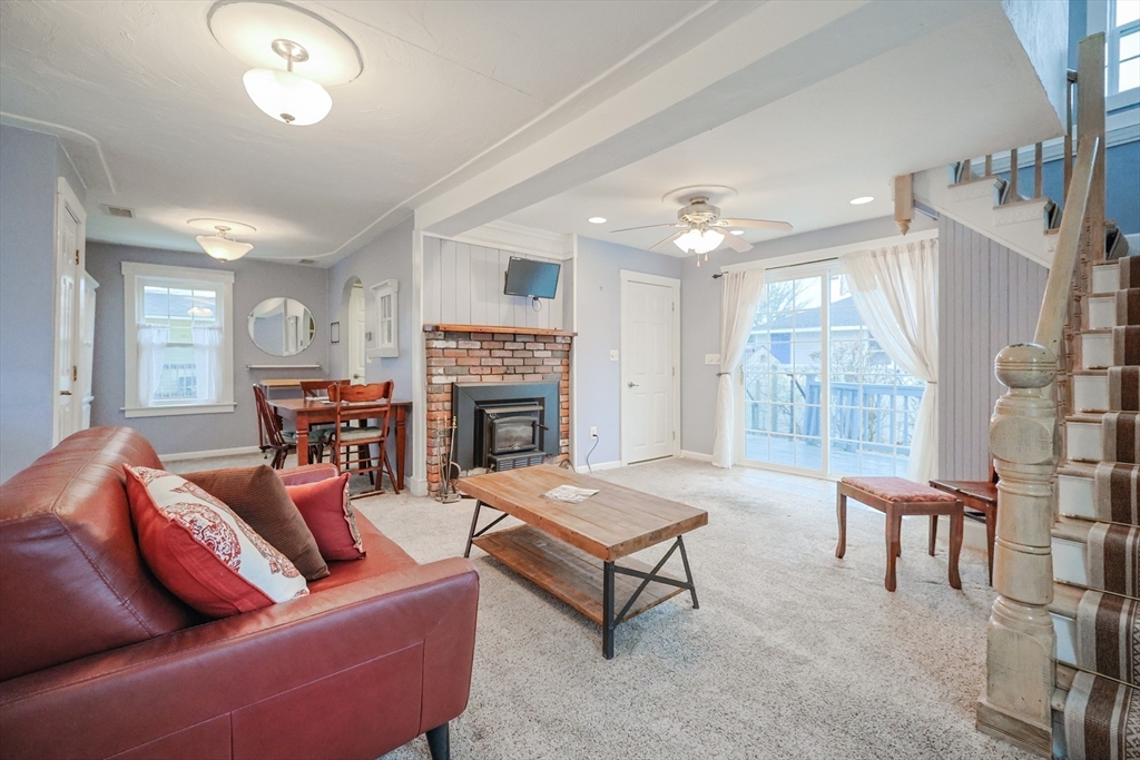 4 Roosevelt Street Wareham, MA 02571 - Photo 12 of 34 a living room with furniture a fireplace and a large window