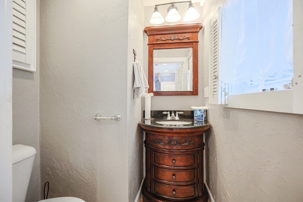4 Roosevelt Street Wareham, MA 02571 - Photo 14 of 34 a bathroom with a toilet sink and mirror