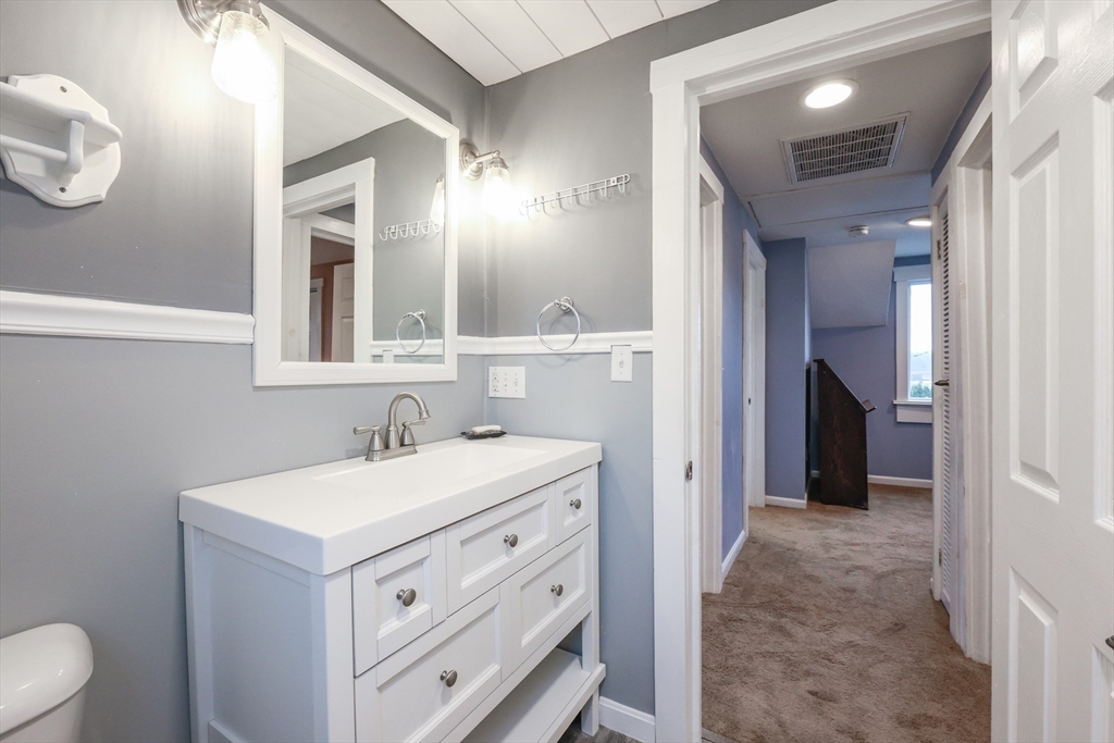 4 Roosevelt Street Wareham, MA 02571 - Photo 20 of 34 a bathroom with a sink a toilet and a mirror