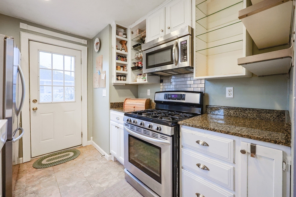 4 Roosevelt Street Wareham, MA 02571 - Photo 5 of 34 a kitchen with stainless steel appliances granite countertop white cabinets a stove top oven a sink and dishwasher